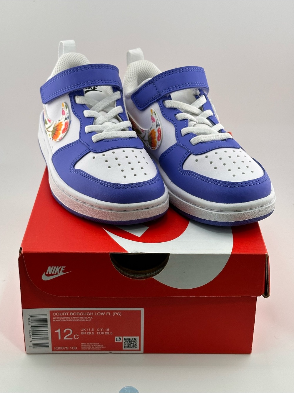 Nike Kids White and Blue Low-Top Sneakers with Floral Swoosh Accent